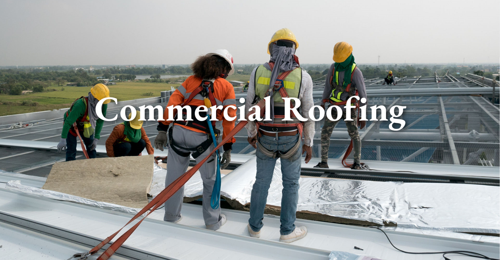 men in safety harnesses performing a commerical roofing repair