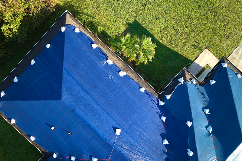 Roof tarp installation on a home